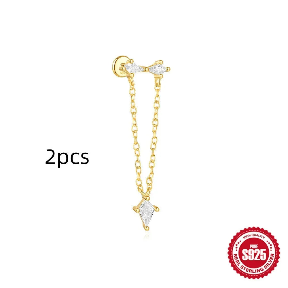 Geometric kite-shaped sterling silver earrings with a gold electroplated chain tassel featuring rhinestones.