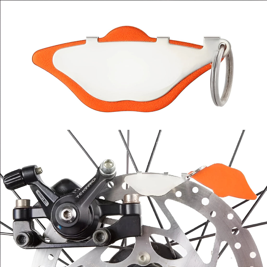 Mountain bike disc brake pads set showing metal linings and adjustment flap in black and orange colour options