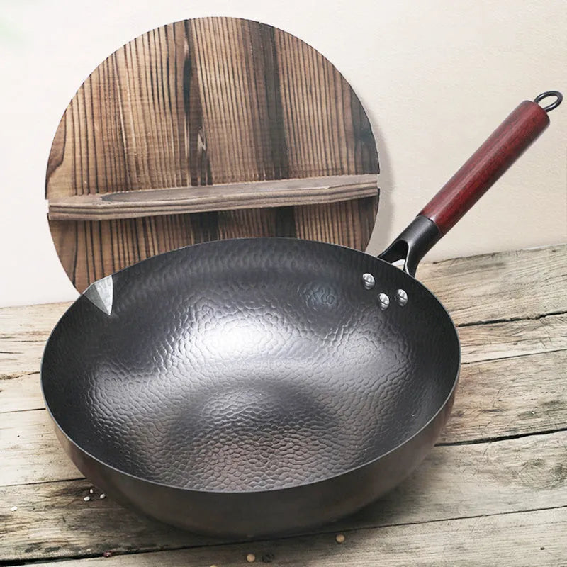 Traditional black iron wok pan with wooden handle measuring 40cm