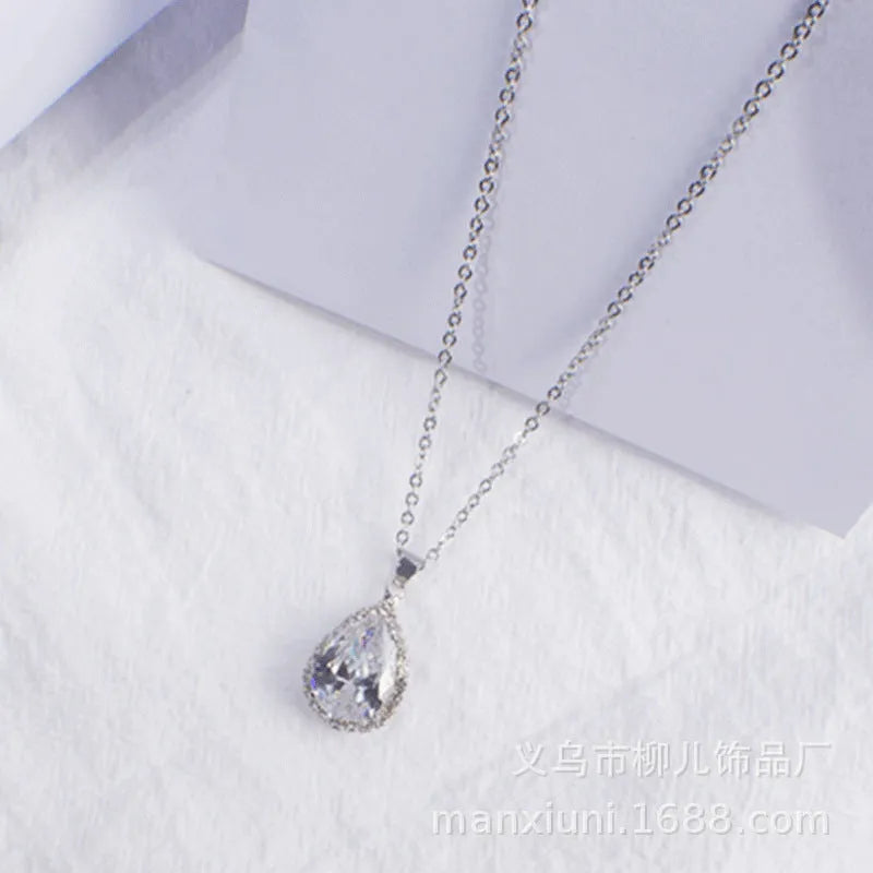 Pink water drop shaped rhinestone necklace with rose gold electroplated alloy pendant on white background