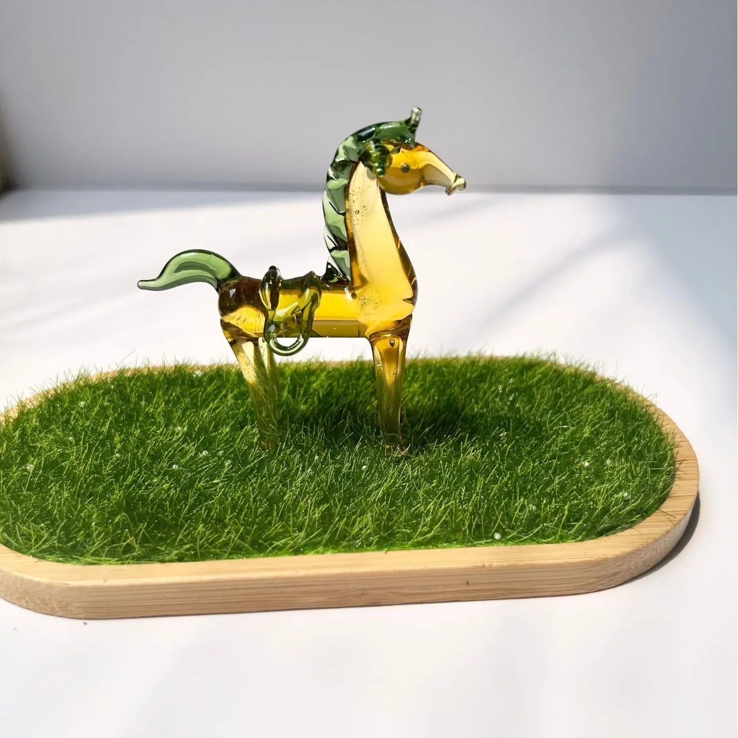 Coloured glaze horse sculpture in brown finish on wooden desk