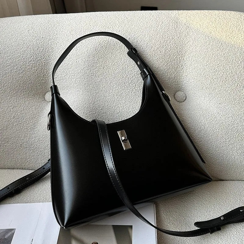 Genuine leather dumpling-shaped crossbody shoulder bag in apricot colour with a front sandwich pocket.