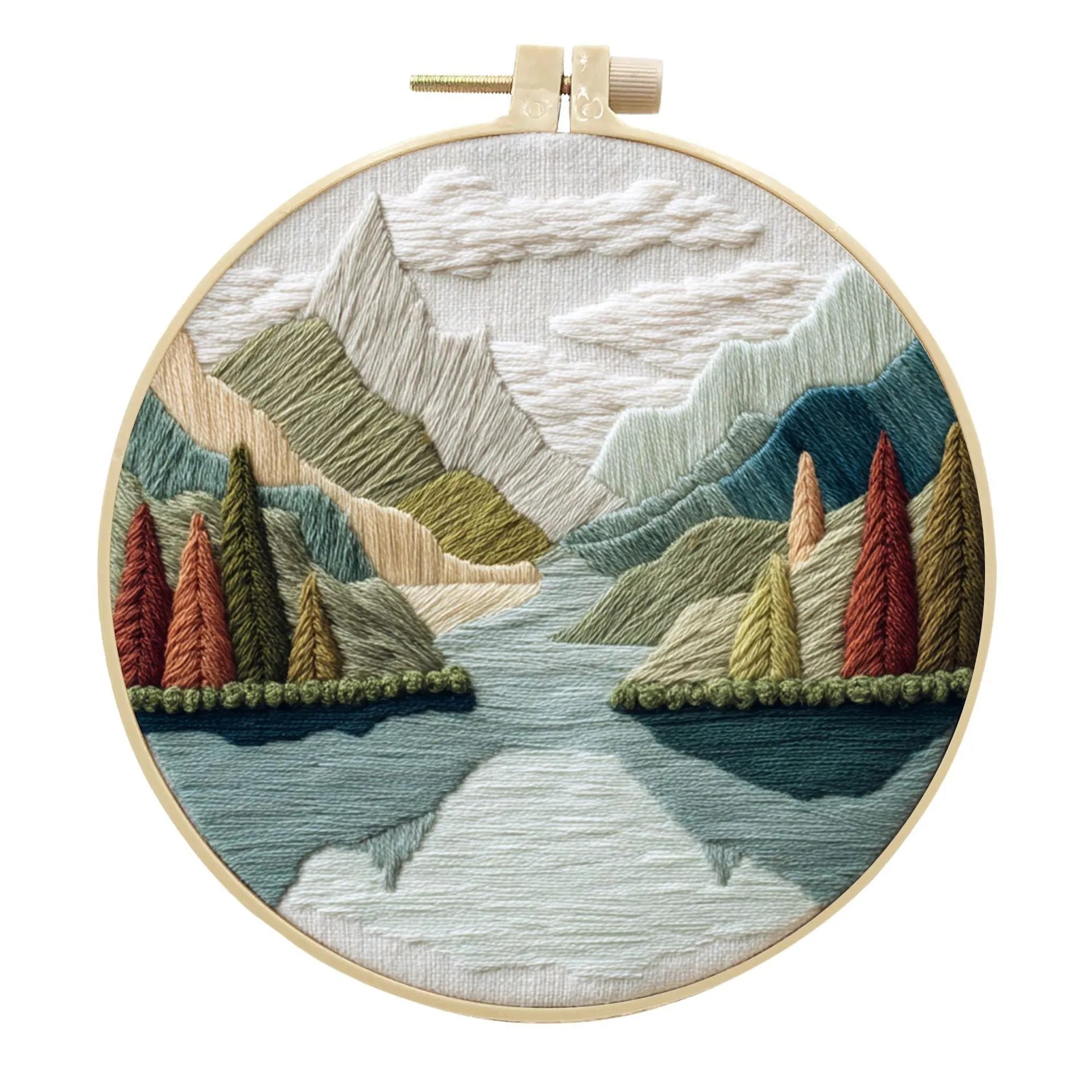 DIY landscape embroidery kit with cotton fabric, bamboo frame, threads and needles arranged for crafting