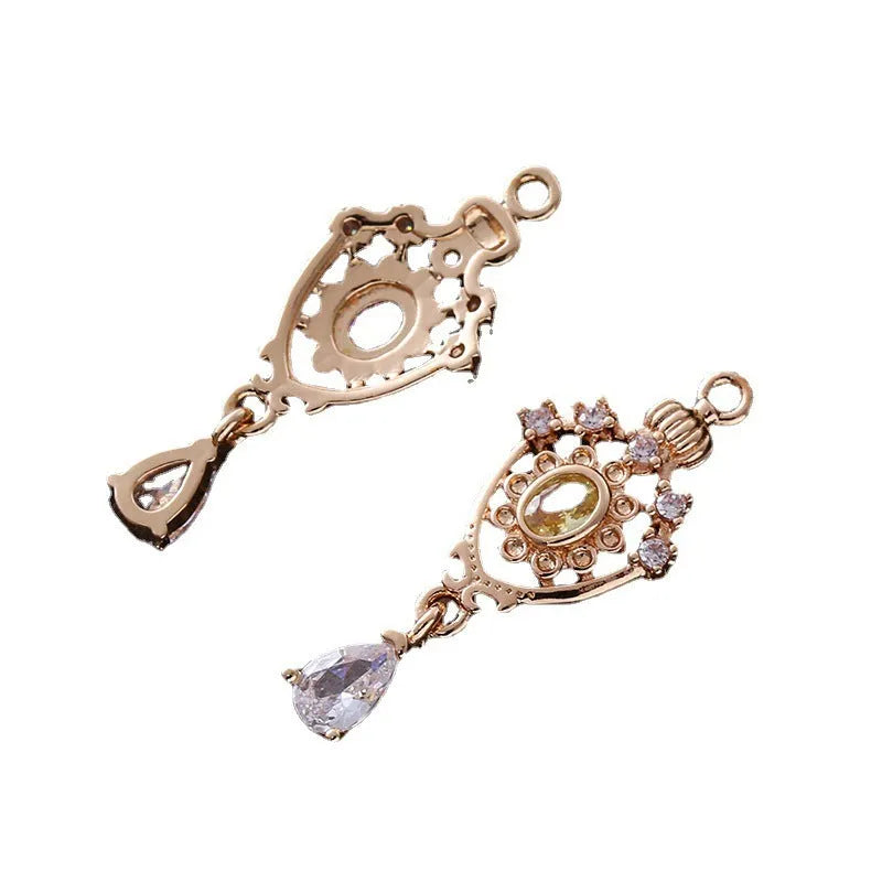 Small hollow water drop-shaped pendant with crown design and micro zircon details in various colours.