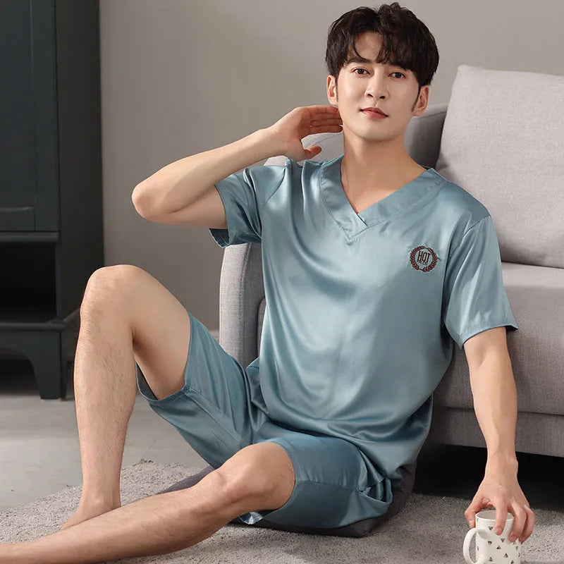 Man wearing a loose grey ice silk short-sleeve pajama shirt and matching shorts.