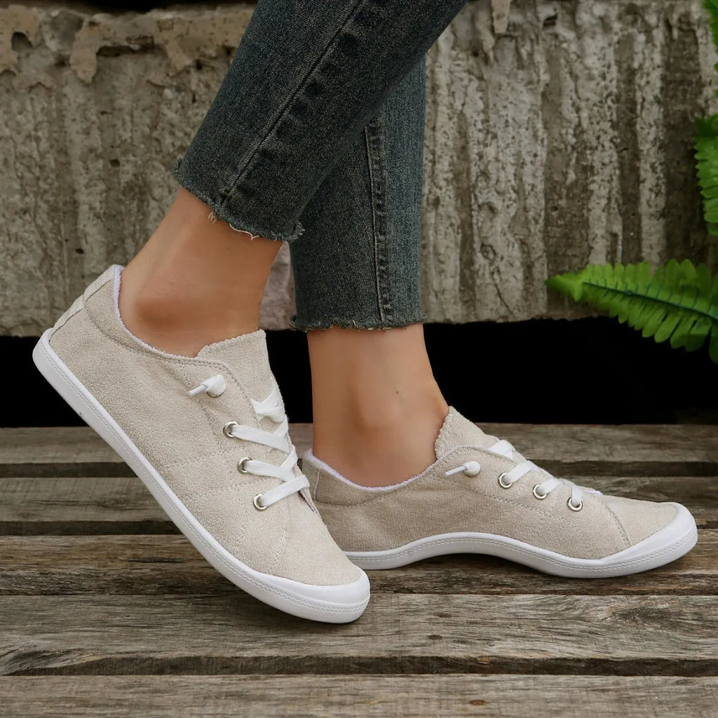 Women's creamy-white fabric low-top casual sneaker with rubber sole