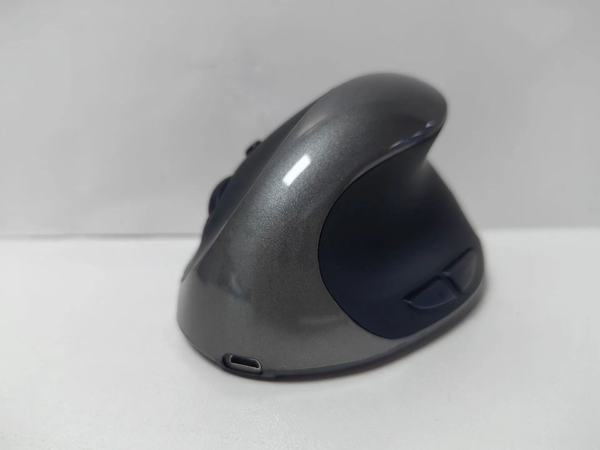 Vertical ergonomic wireless mouse showing upright design with USB connector and multiple colour options