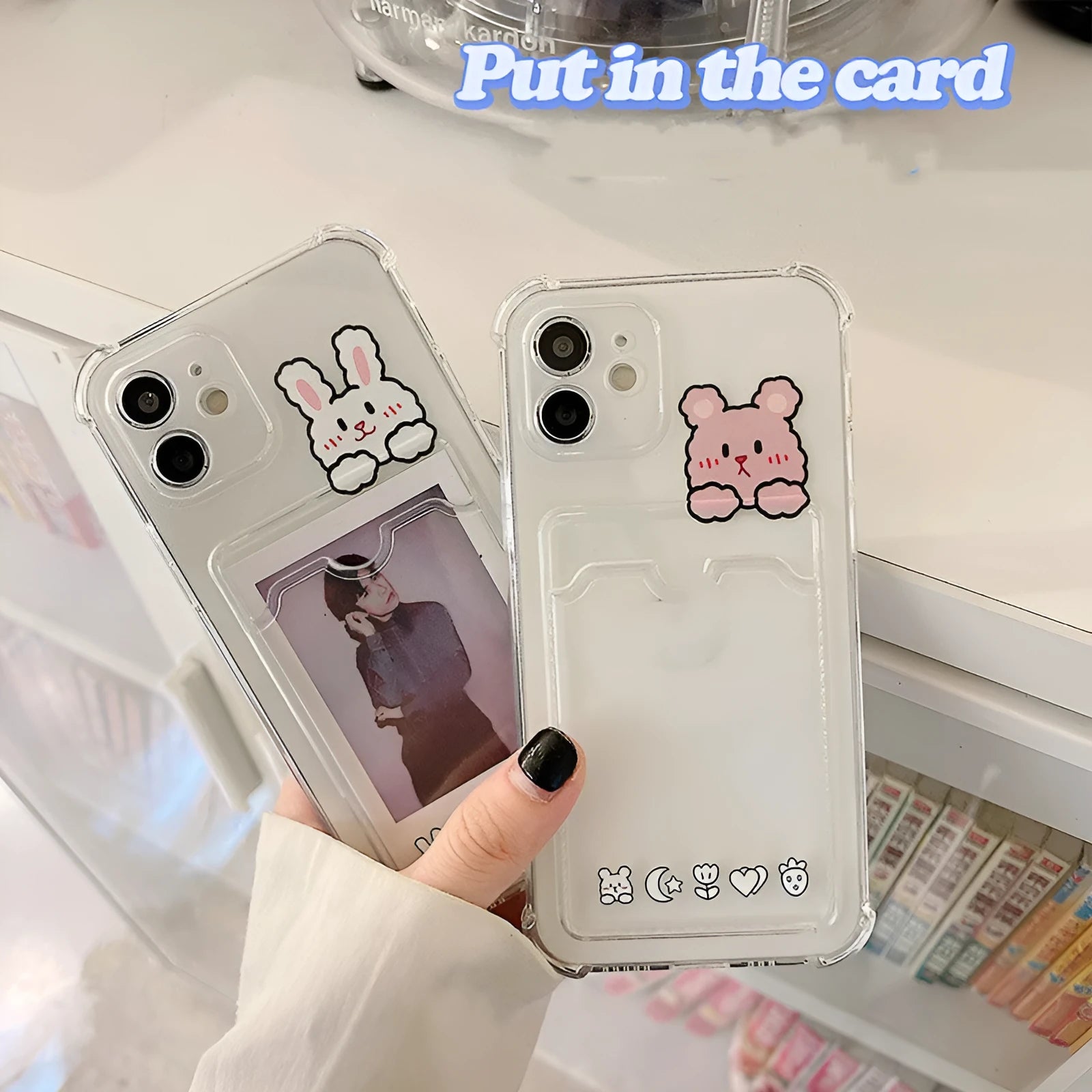 Transparent cartoon-themed iPhone case with a card slot, shown on an iPhone.