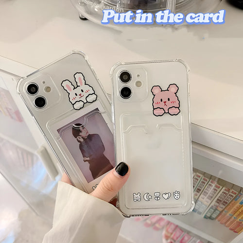 Transparent cartoon-themed iPhone case with a card slot, shown on an iPhone.