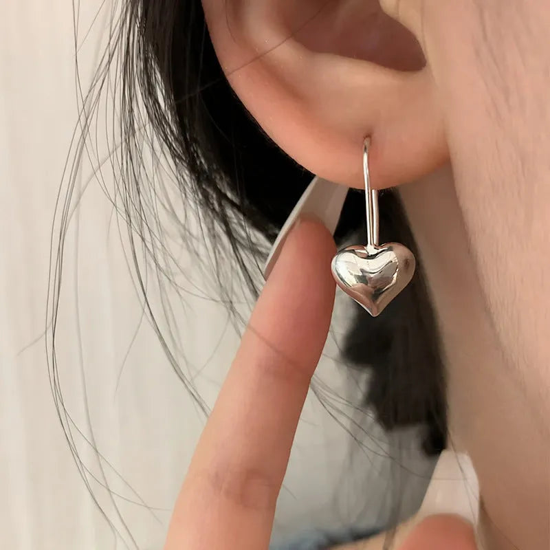 Three-dimensional glossy heart-shaped earrings with white gold colour finish and Korean-style design
