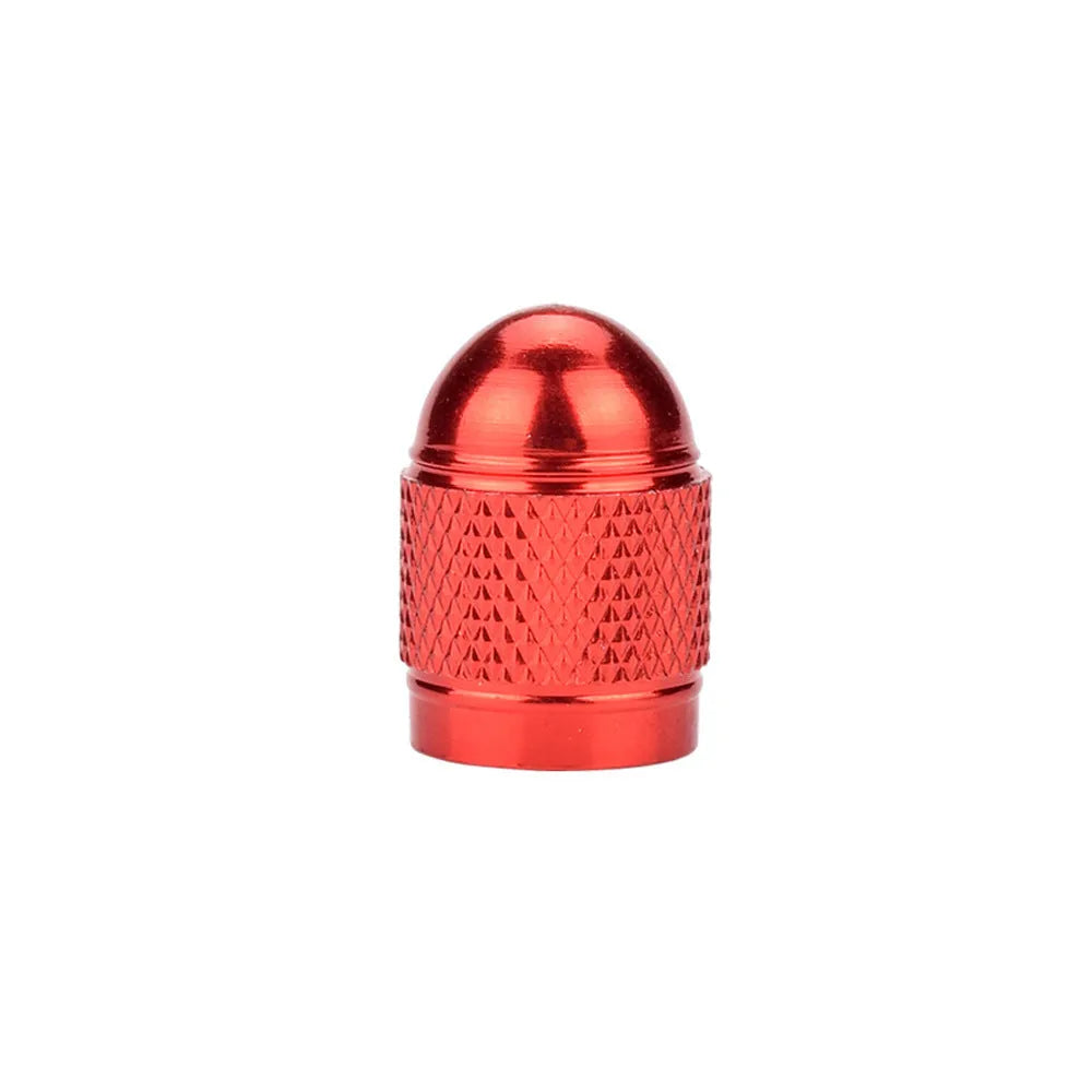 Aluminium alloy mountain bike tyre valve cap in multiple colour choices on a bicycle wheel.