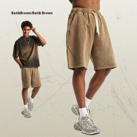 Men's loose-fit pure cotton terry shorts in a batik grey colour, showing street fashion style.