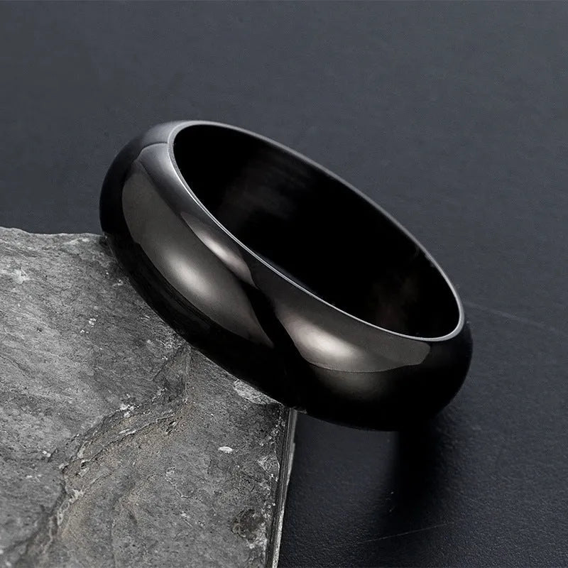 Glossy electroplated titanium steel ring shown in gold, black, and steel colour finishes on a grey background.