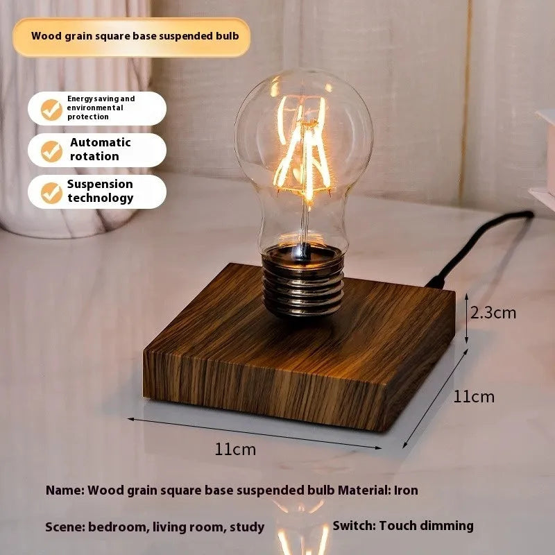 Iron art suspension bulb night lamp on black wood grain base measuring 11cm