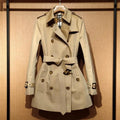 Khaki women's double-breasted trench coat with long flight sleeves, button front.