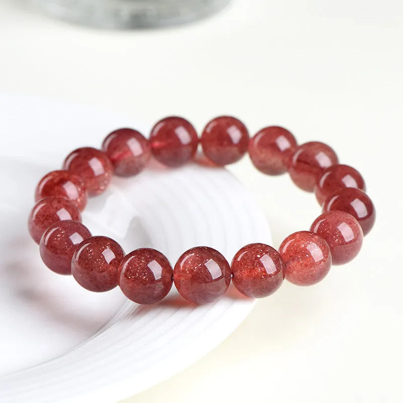 Natural strawberry quartz bracelet with geometric red crystal beads in three size options from 7mm to 10.8mm diameter
