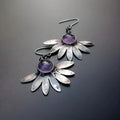 Close-up of purple Bohemian style flower earrings with resin gemstones and Zodiac animal detailing on alloy.