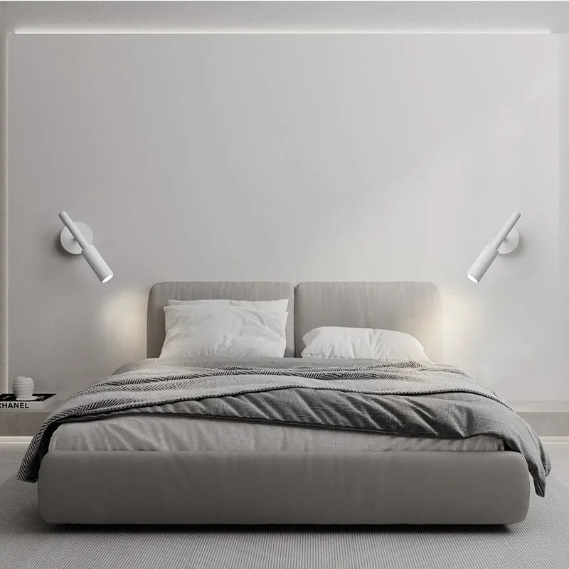 Modern wrought iron wall lamp in black or white, 100mm by 230mm, with three colour light options.