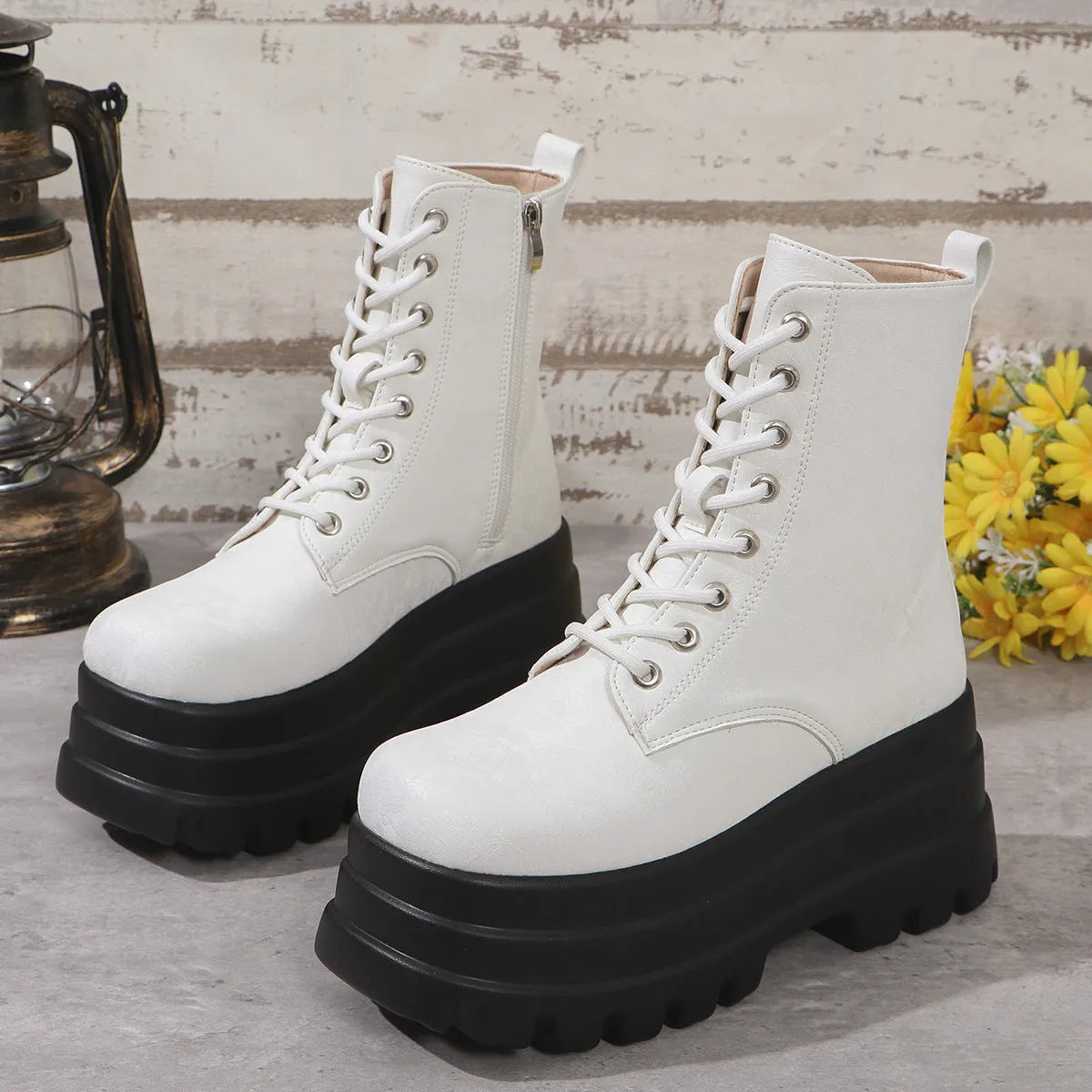 Women's black retro platform Martin boots with patchwork toe and side zip.