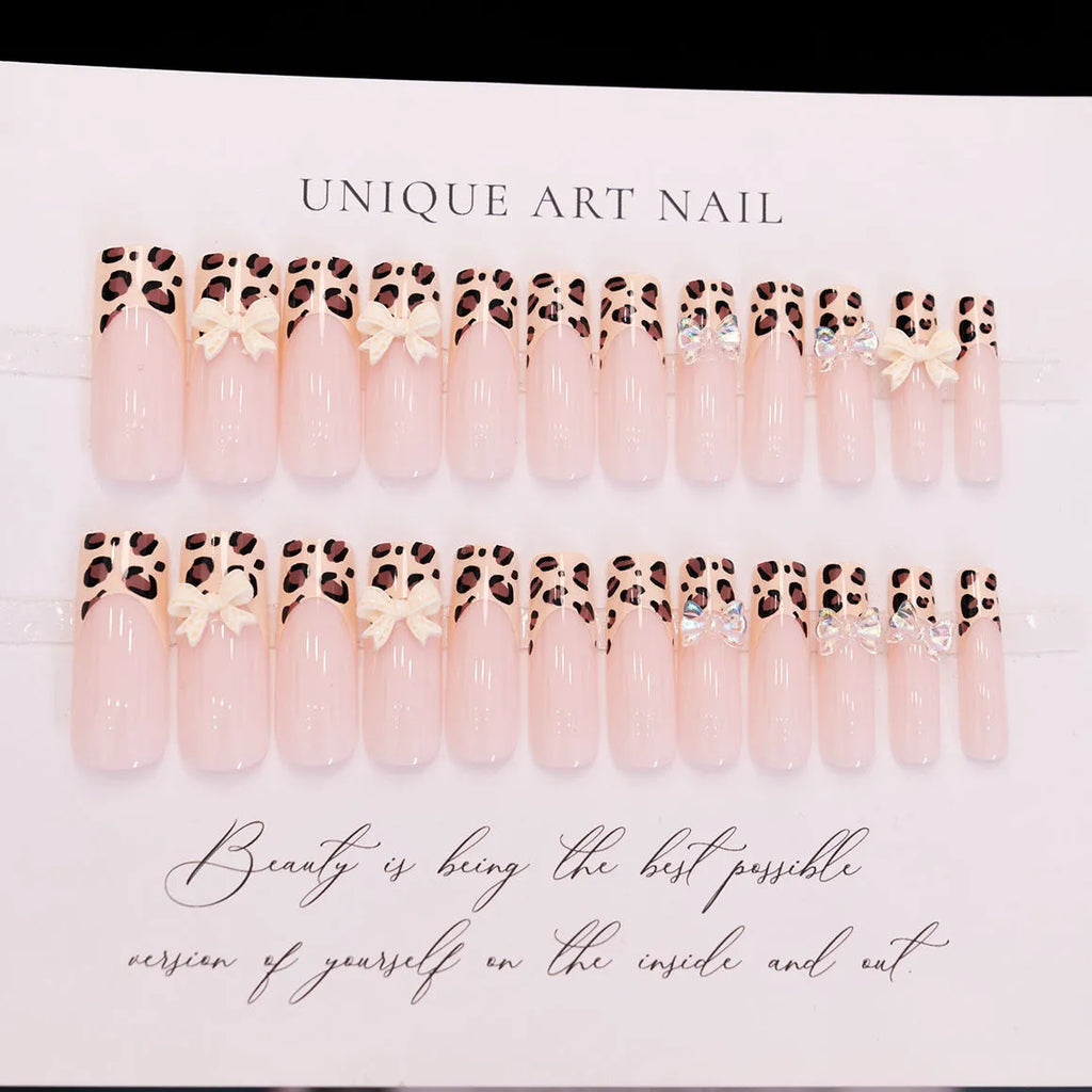 Leopard print butterfly design nail art stickers and gems on a white background.