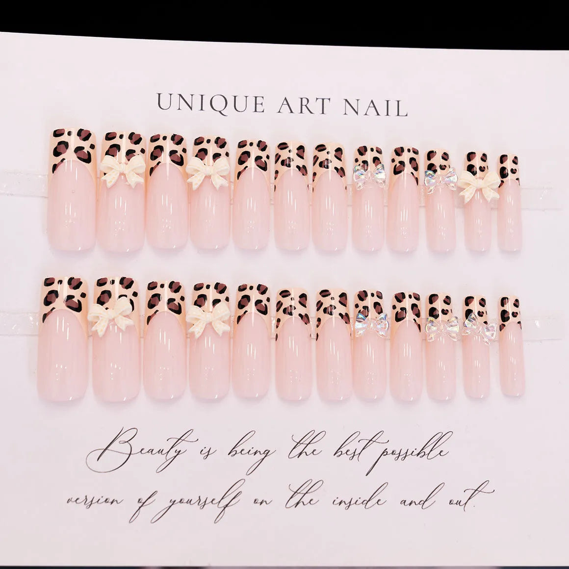 Leopard print butterfly design nail art stickers and gems on a white background.