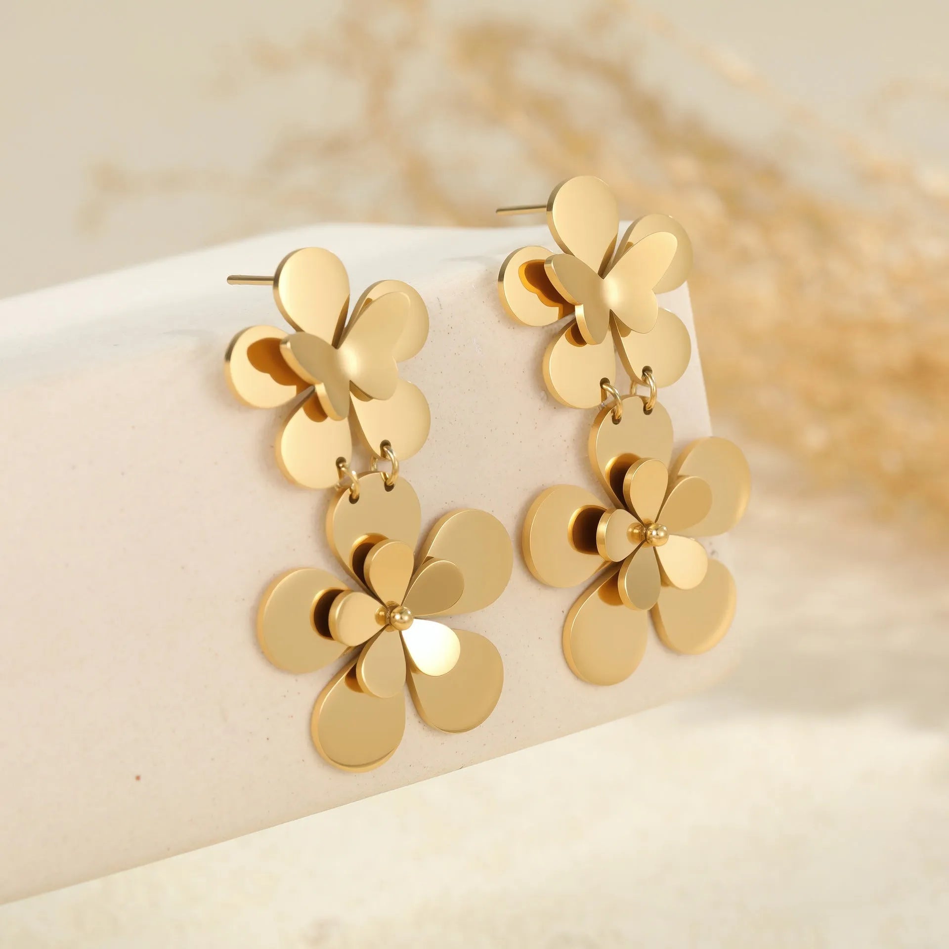 Gold electroplated stainless steel earrings with flower and butterfly designs for women