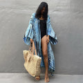 Woman wearing a printed cotton beach cover-up blouse in a DN0712 series colour.