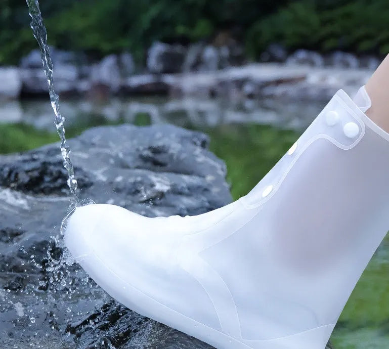 White PVC high top reusable shoe covers for women, shown on a foot, for water resistant protection.