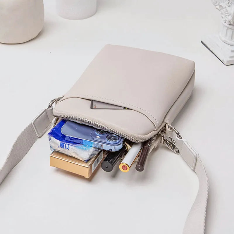 Small solid colour mobile phone crossbody bag in PU leather measuring 14.5cm wide