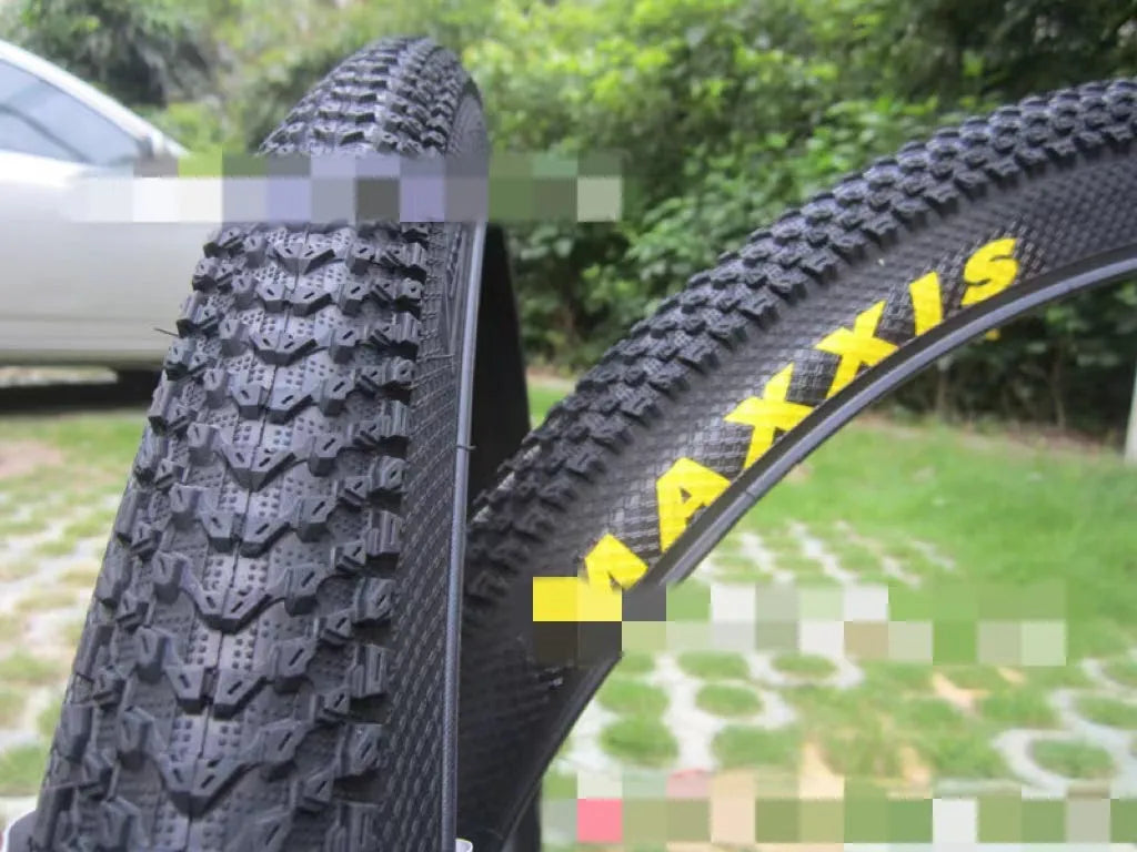 Mountain bike tyre with puncture-proof construction, shown in multiple sizes including 26x1.95 and 27.5x2.1