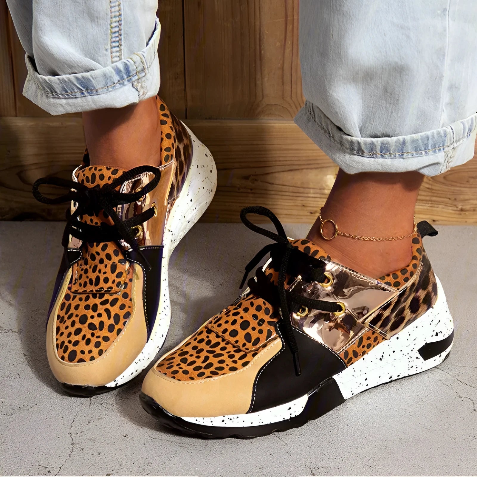 Women's black suede casual sneakers with a wedge heel and round toe on a light background.