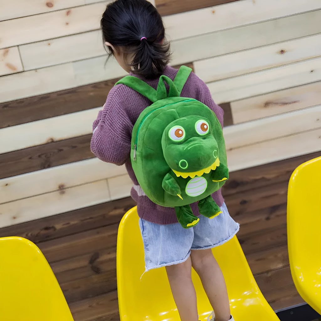 Blue soft plush dinosaur backpack for children with embroidered details and a soft carry handle.