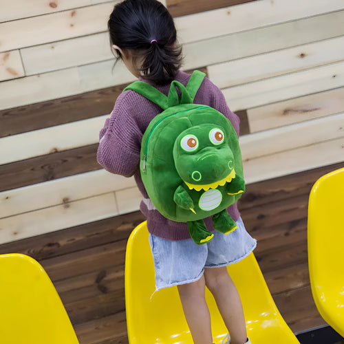 Blue soft plush dinosaur backpack for children with embroidered details and a soft carry handle.