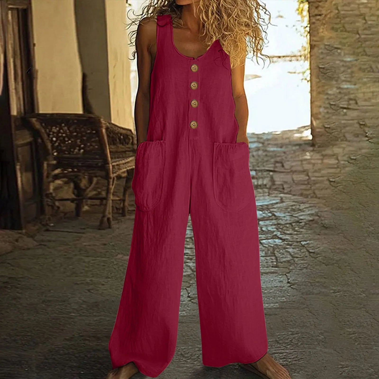Sleeveless wide leg cotton jumpsuit in peacock green colour showing loose fit and pocket detail.