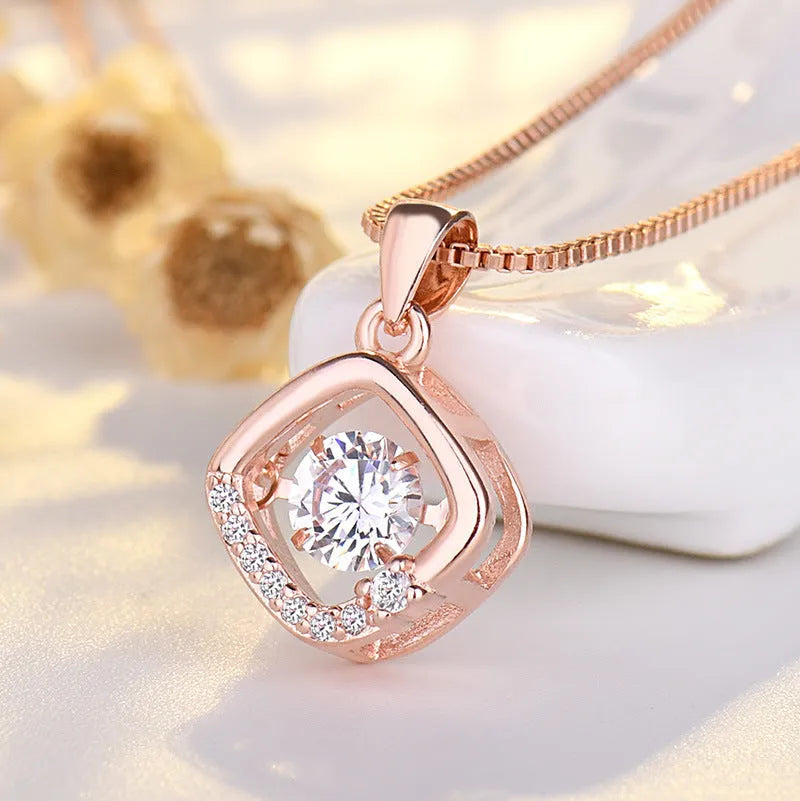 Silver heart-shaped pendant necklace with a crown and bow design on a sterling silver chain.