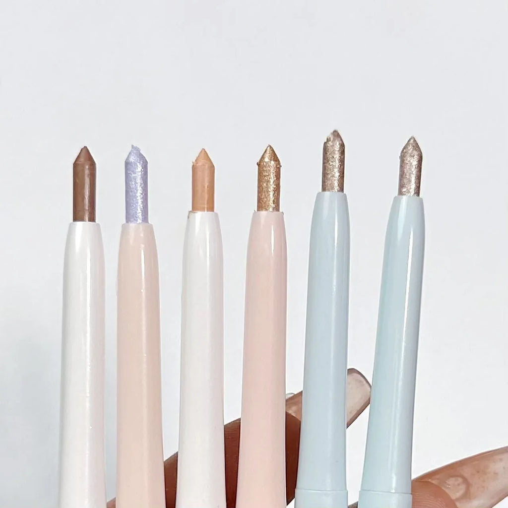 Waterproof 2-in-1 eyeshadow and highlighter pen in assorted colours on a white background.