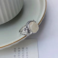 Adjustable vintage-style copper ring with white chalcedony finish showing open mouth design