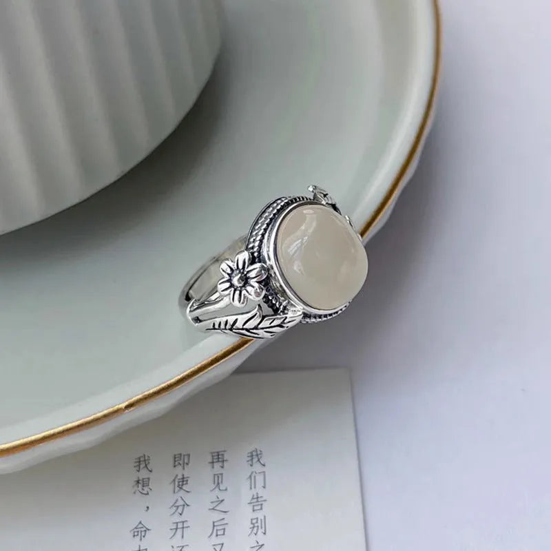 Adjustable vintage-style copper ring with white chalcedony finish showing open mouth design