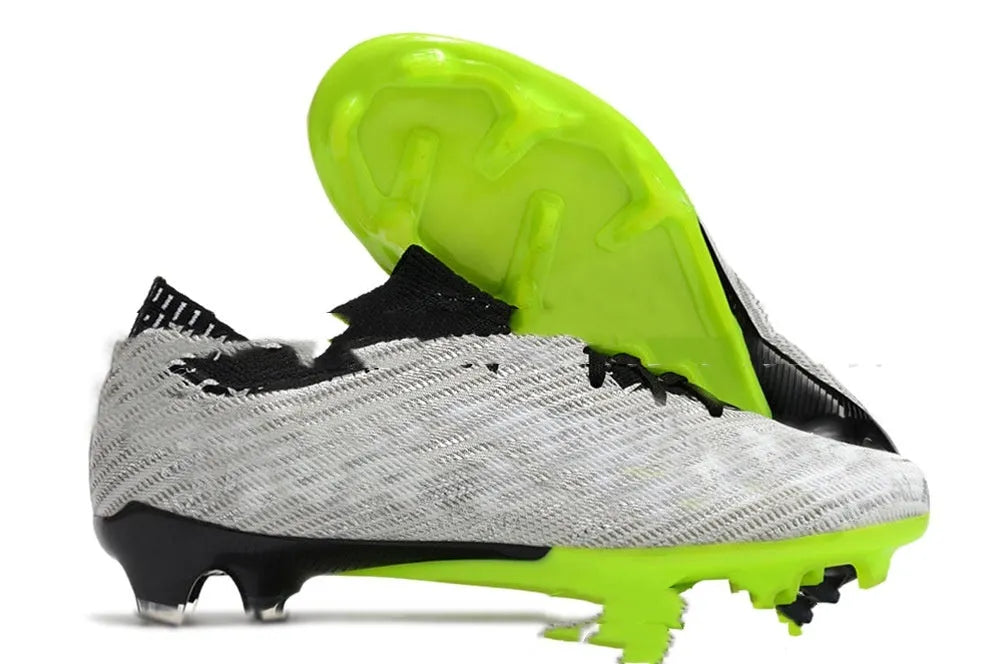 Men's low-top football shoes with knitted upper, rubber FG studs, and front lace-up closure.