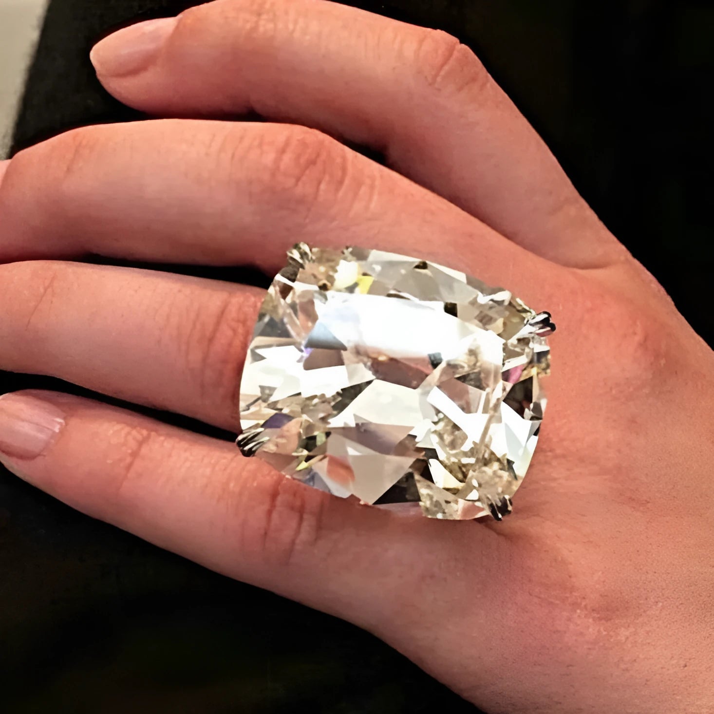 Simple white gold colour alloy ring with a geometric design and an inlaid square diamond.