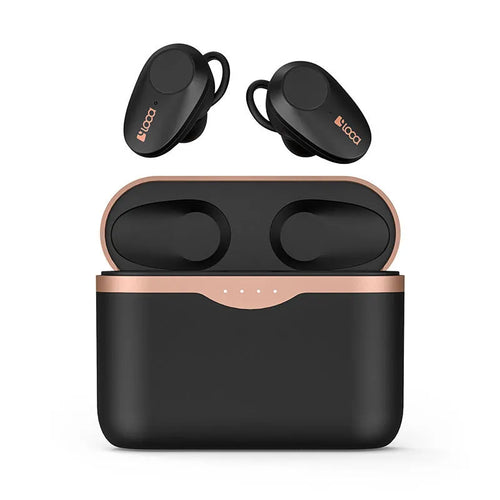 Black wireless Bluetooth headset with bilateral earpieces and a charging stand on a table.