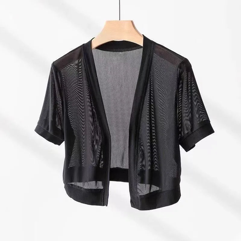 Woman wearing a wine red long sleeve shirt with an irregular French collar, bell sleeves, and a tie front.