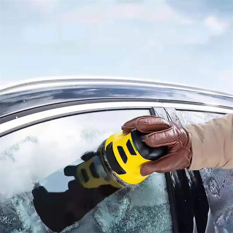 Yellow cordless electric ice scraper with USB charging cable on a car windscreen.