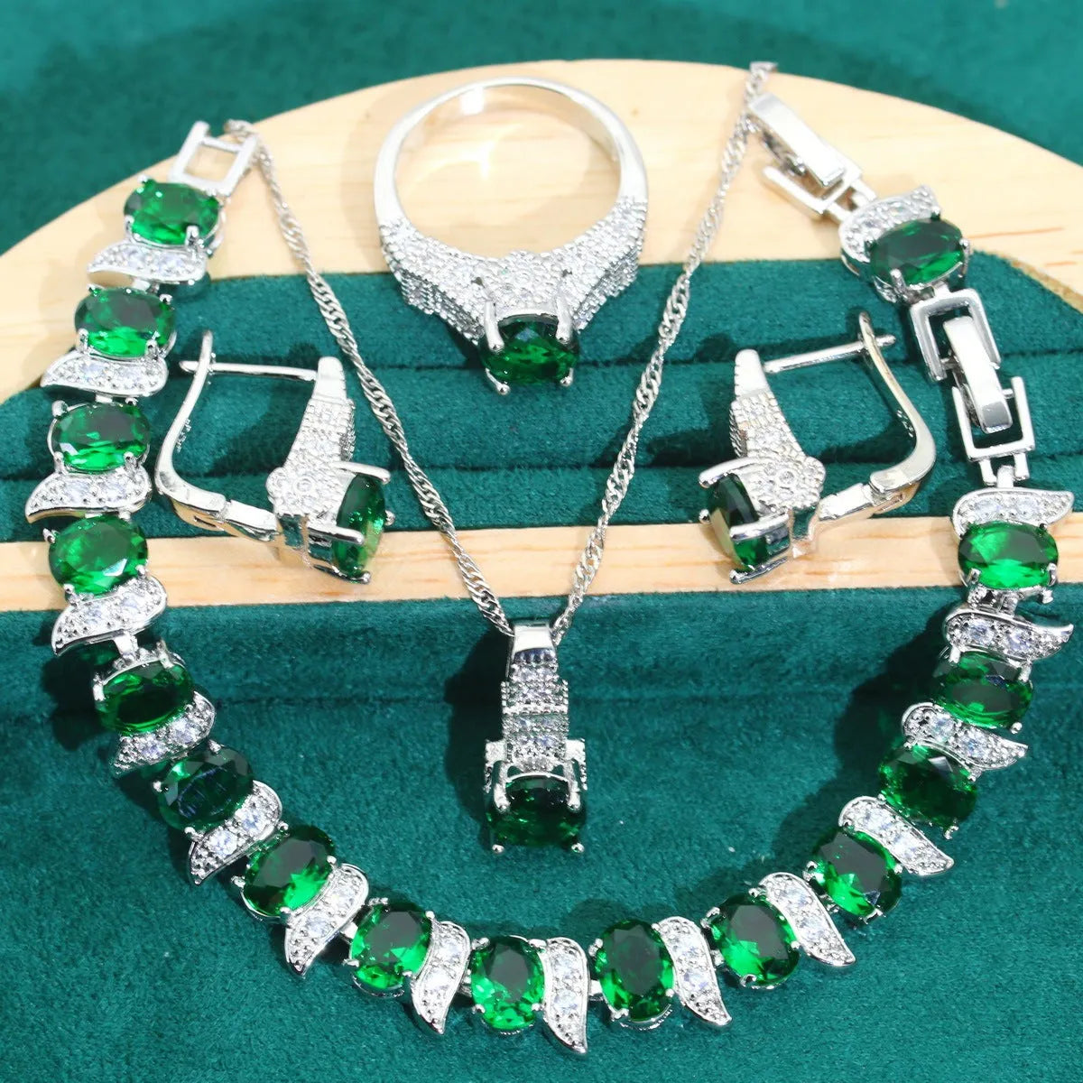 Four-piece bridal jewellery set showing necklace, earrings, ring, and bracelet with zircon alloy pendants