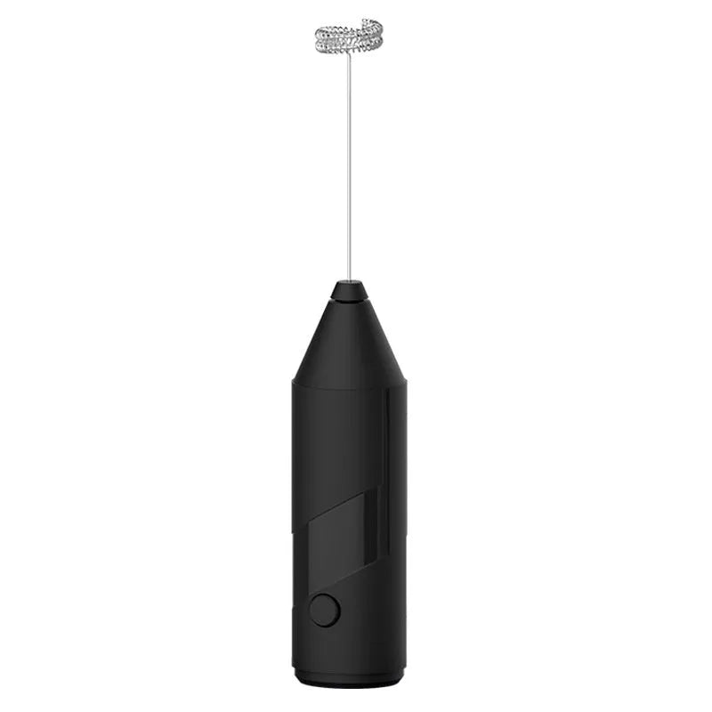 Compact black handheld USB rechargeable milk frother with stainless steel whisk on a kitchen counter.