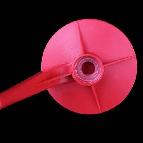 Red plastic Magic Tap soda dispenser attached to an inverted 2-litre bottle for serving fizzy drinks