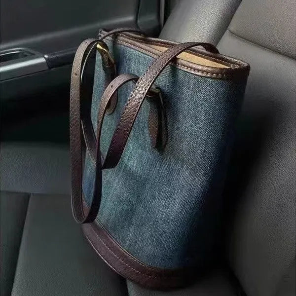 Blue denim patchwork one-shoulder bucket handbag showing retro style and large capacity.