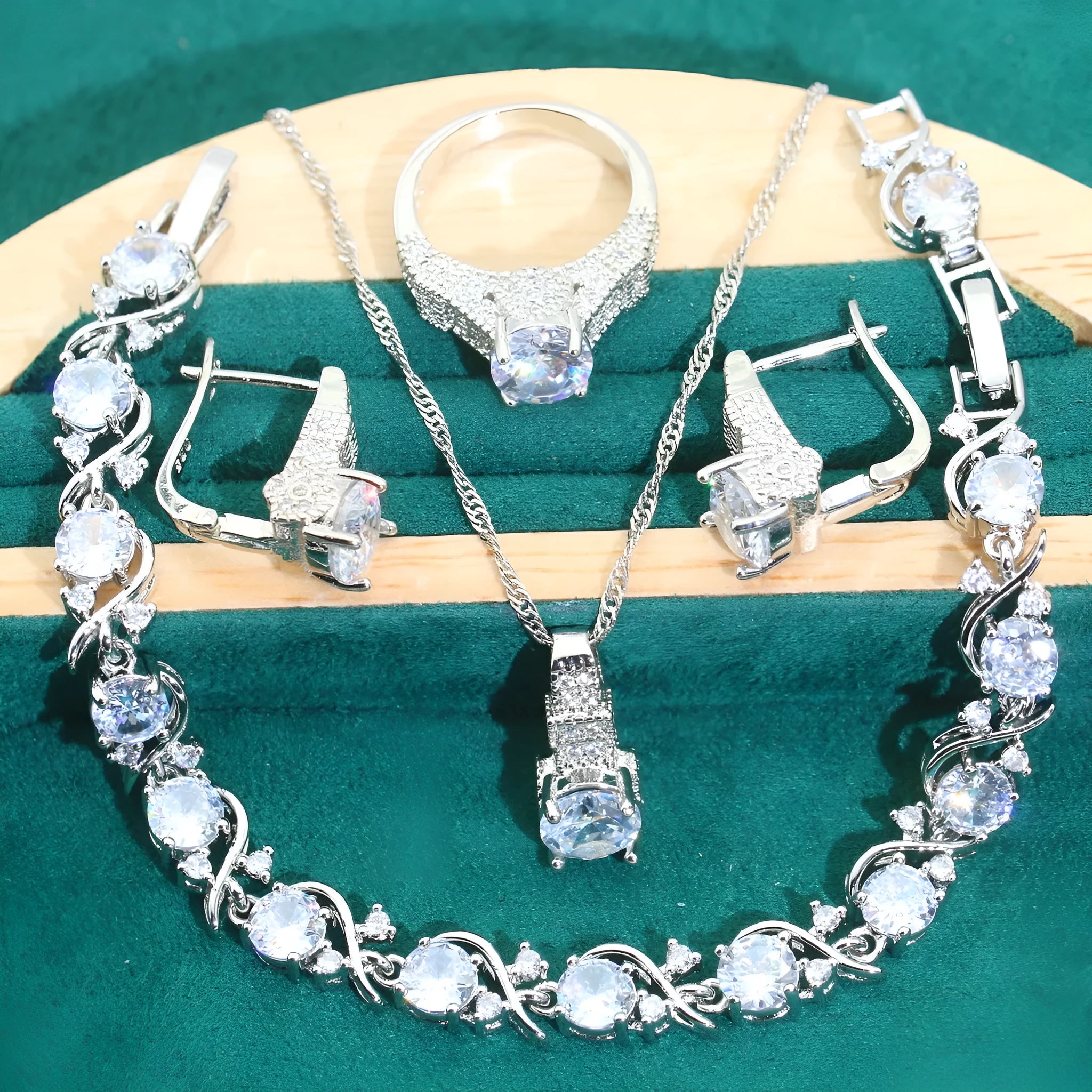 Four-piece bridal jewellery set showing necklace, earrings, ring, and bracelet with zircon alloy pendants