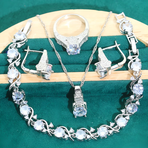 Four-piece bridal jewellery set showing necklace, earrings, ring, and bracelet with zircon alloy pendants