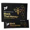 Black jar of T1 Thai honey with clear label on a kitchen counter